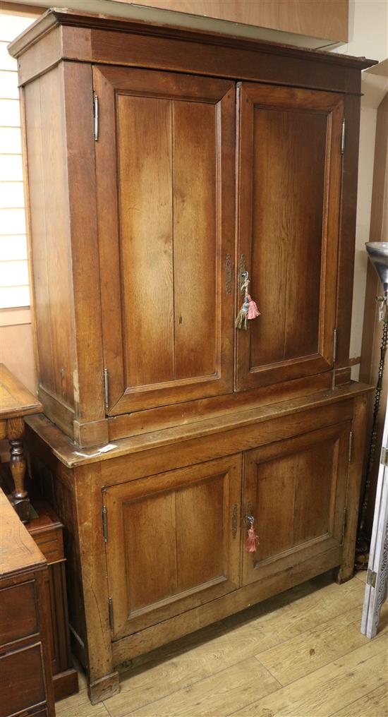 A 19th century French two part oak cupboard W.145cm